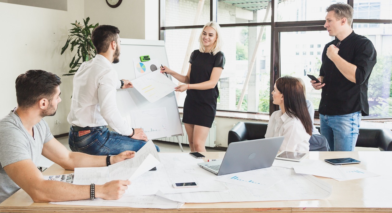 Business team meeting and presentation in modern office discussing charts and strategy
